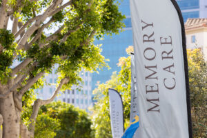 Exterior view of a Memory Care community with welcoming banner displayed outside the entrance