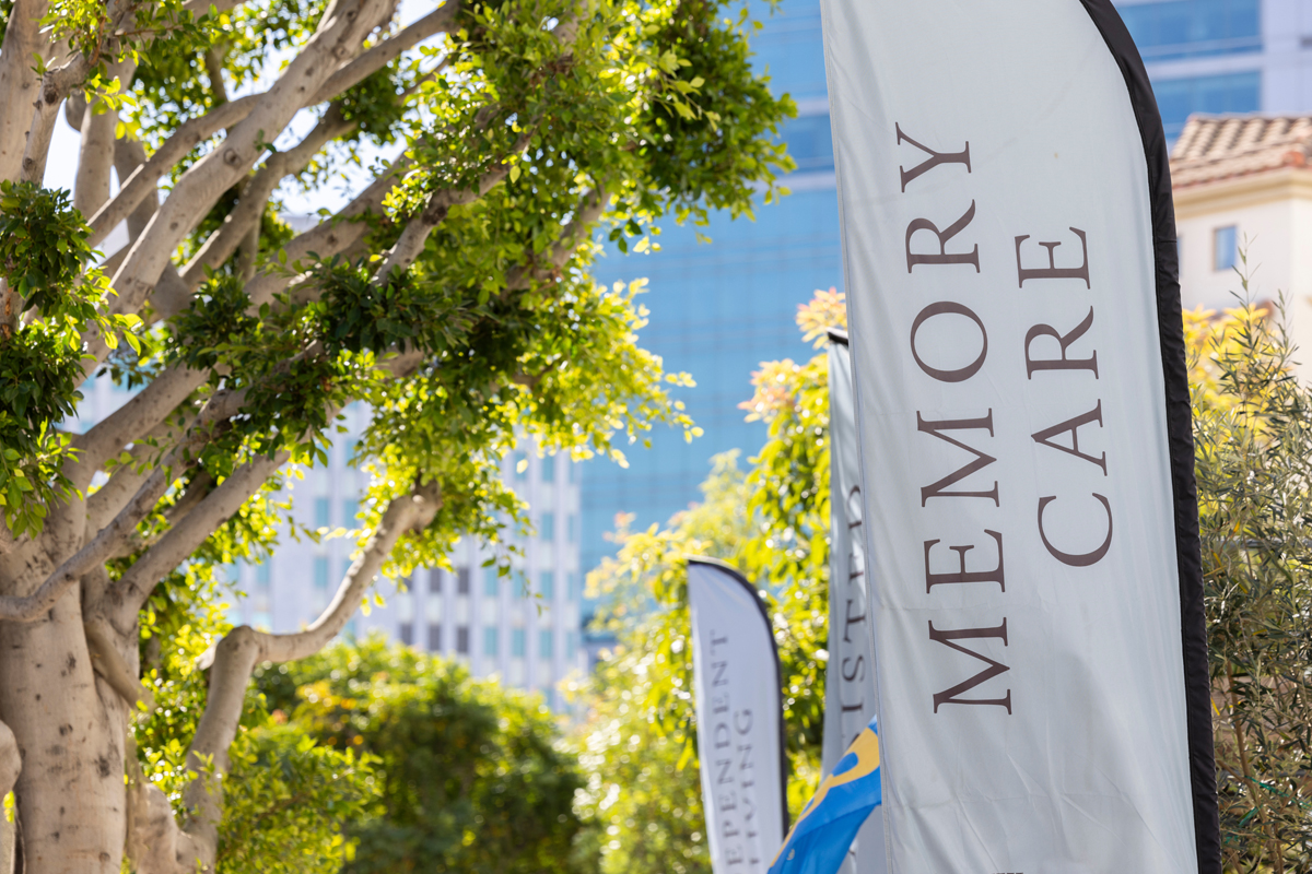 Exterior view of a Memory Care community with welcoming banner displayed outside the entrance