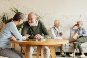 Happy seniors enjoying time in common area of assisted living facility.